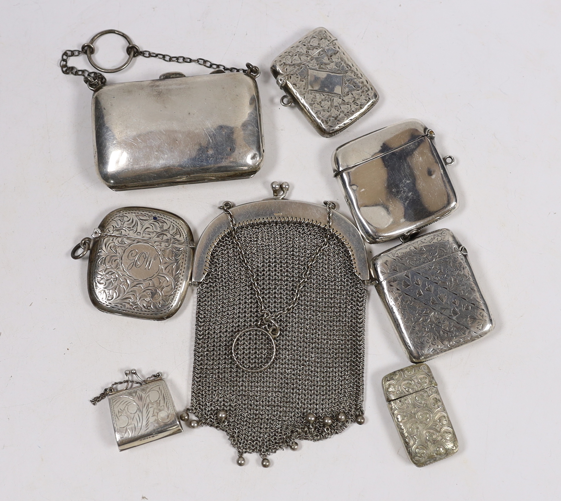 Four assorted early 20th century silver vesta cases and one base metal vesta case, two silver purses including mesh link and a small modern silver 'handbag' pill box.